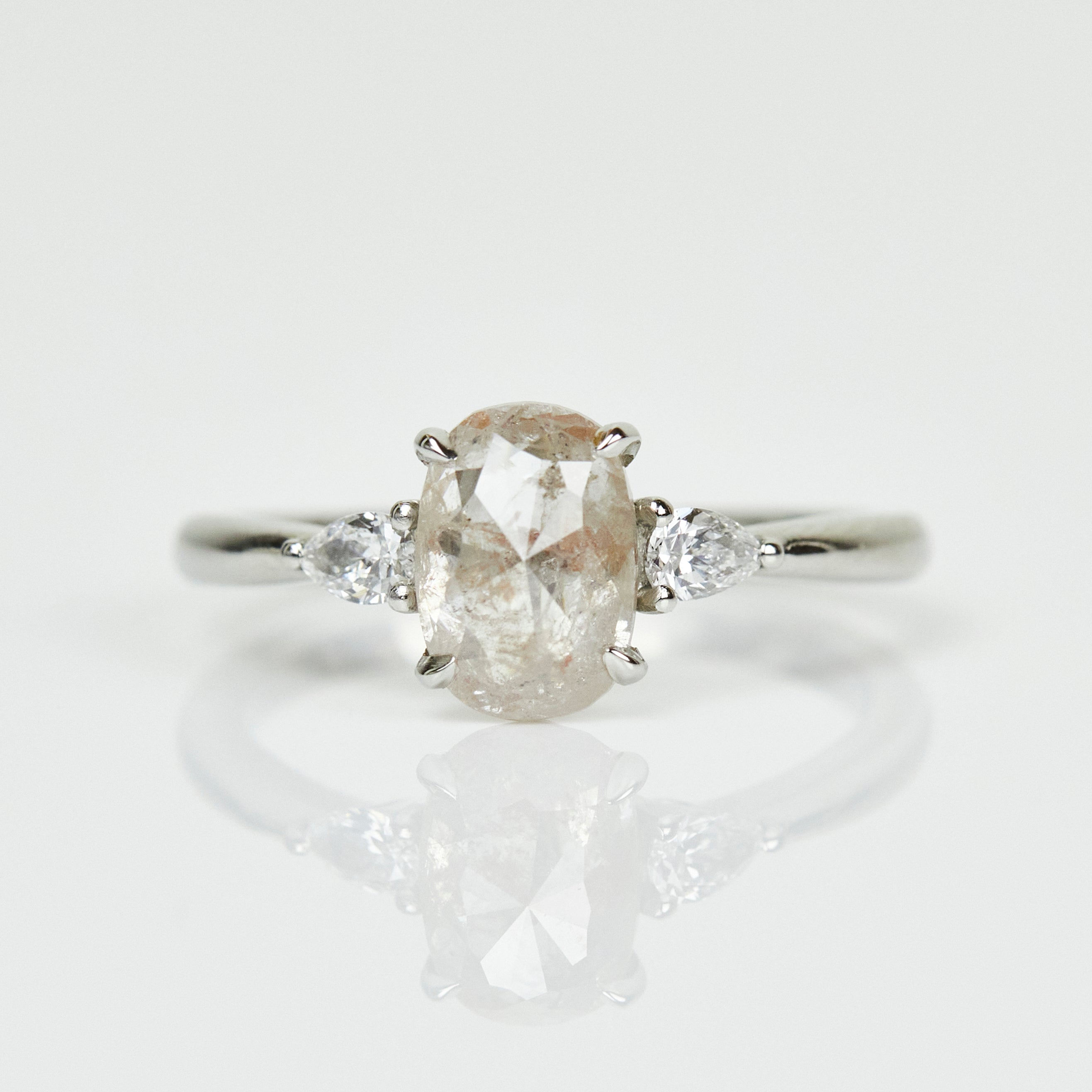 Platinum salt and pepper oval diamond engagement trilogy ring