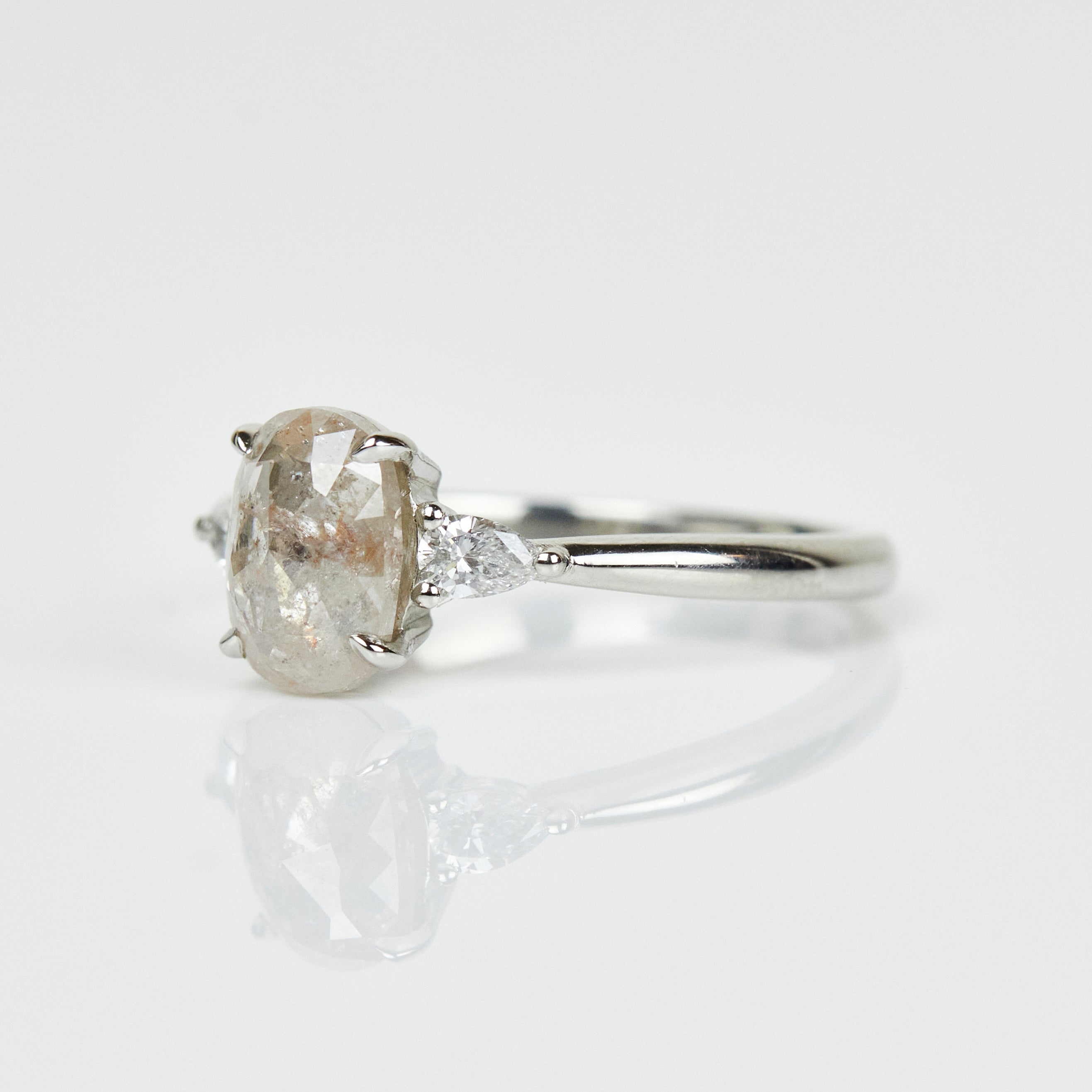 Platinum salt and pepper oval diamond engagement trilogy ring