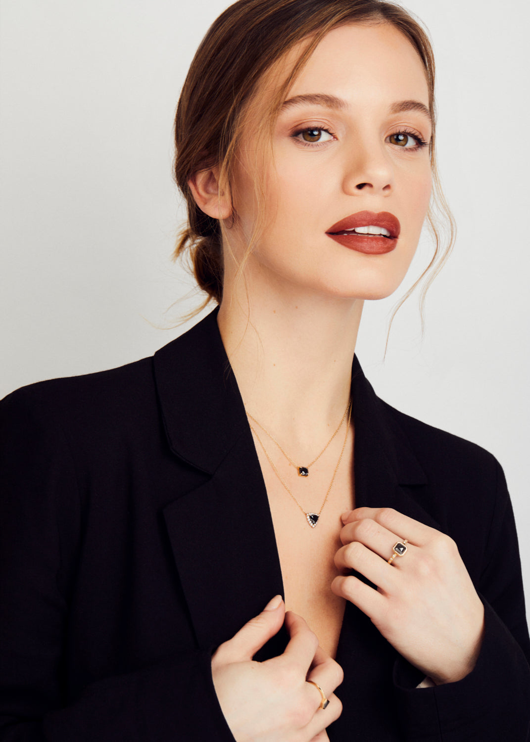 Black diamond triangle halo necklace with white diamonds in 18ct yellow gold.