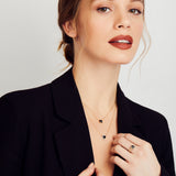 Black diamond triangle halo necklace with white diamonds in 18ct yellow gold.