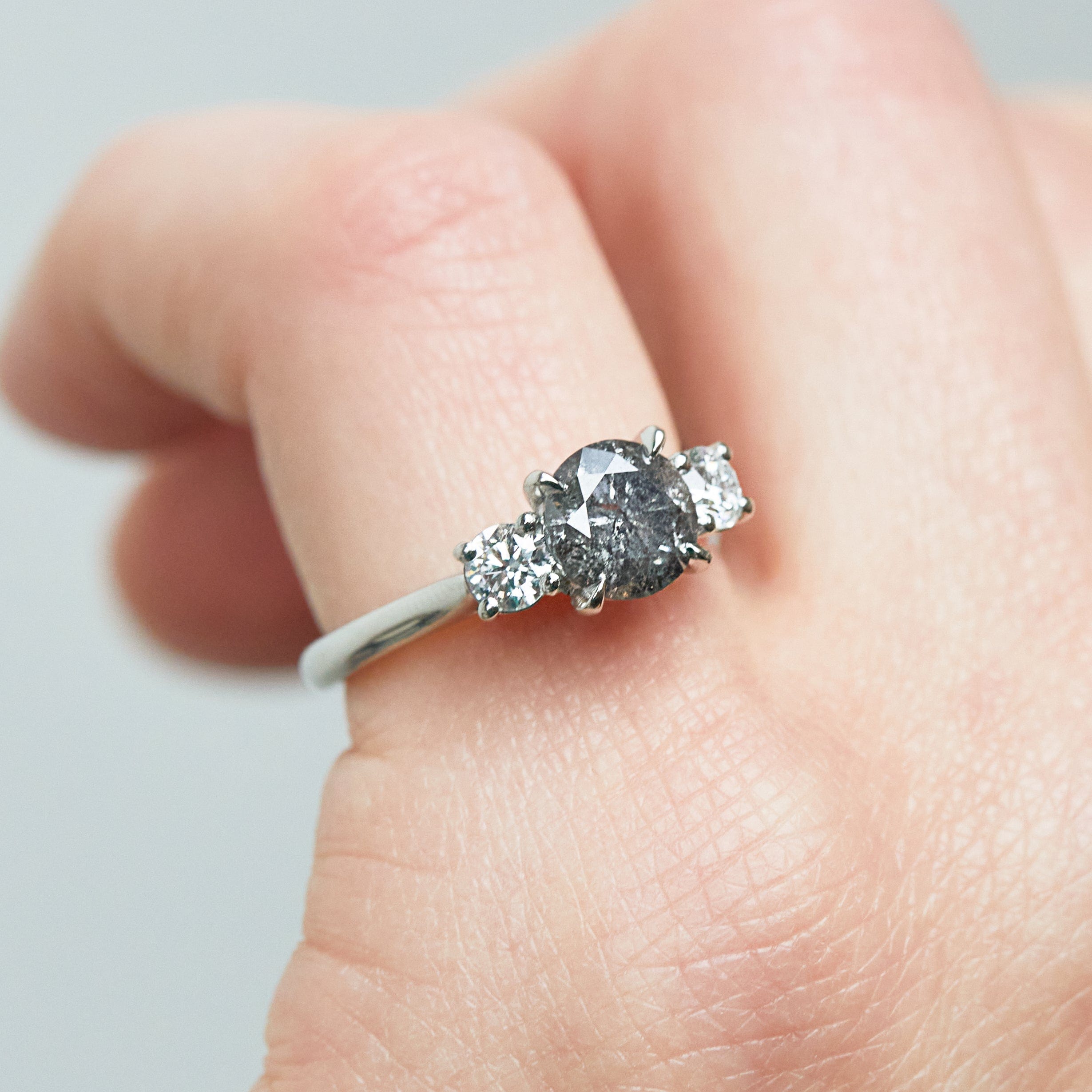 Platinum salt and pepper round brilliant cut diamond engagement trilogy ring