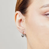 Kite-shaped salt and pepper diamonds with round diamonds in 18ct yellow gold.