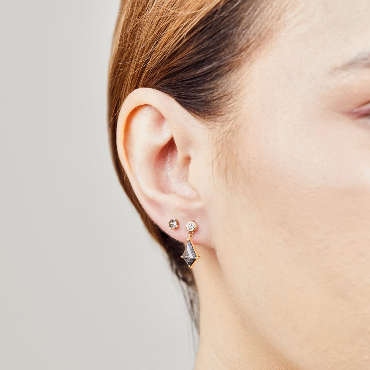 Kite-shaped salt and pepper diamonds with round diamonds in 18ct yellow gold.