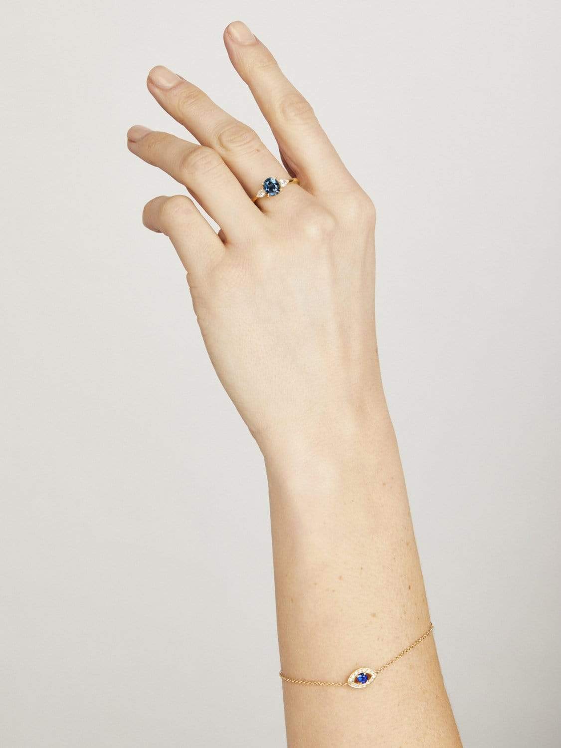 Blue sapphire evil eye bracelet with diamonds in 18ct yellow gold.