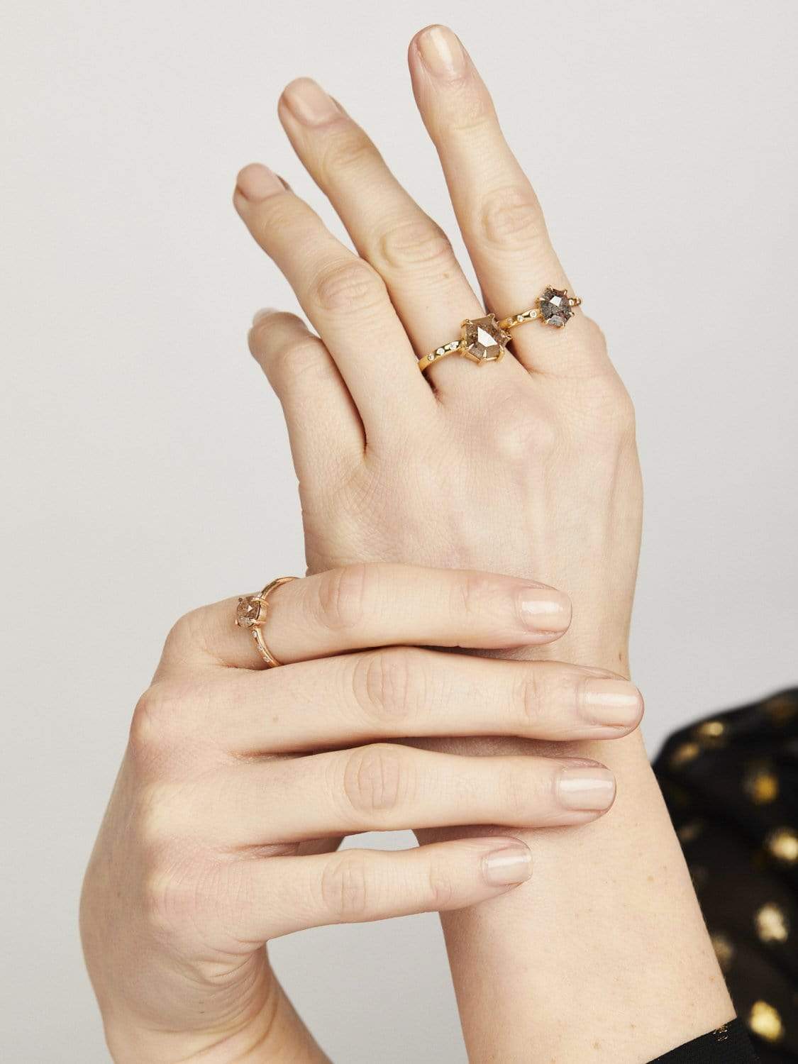 Hexagon-shaped diamond engagement ring with a gold band and round diamonds