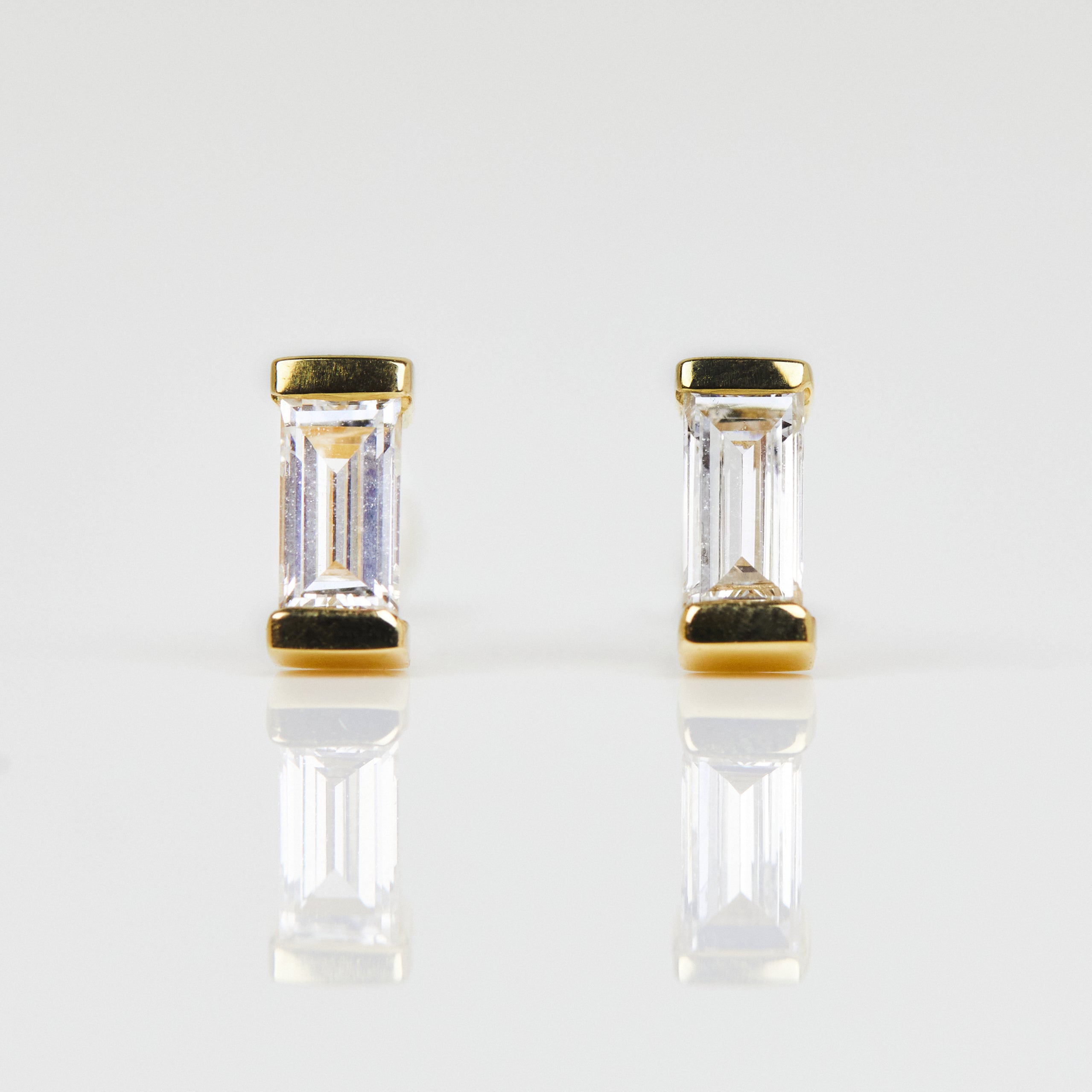White baguette-cut lab-grown diamond earrings set in 18ct yellow gold.