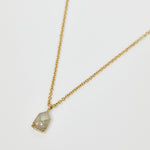 Icy grey shield-shaped diamond necklace in 18ct yellow gold.
