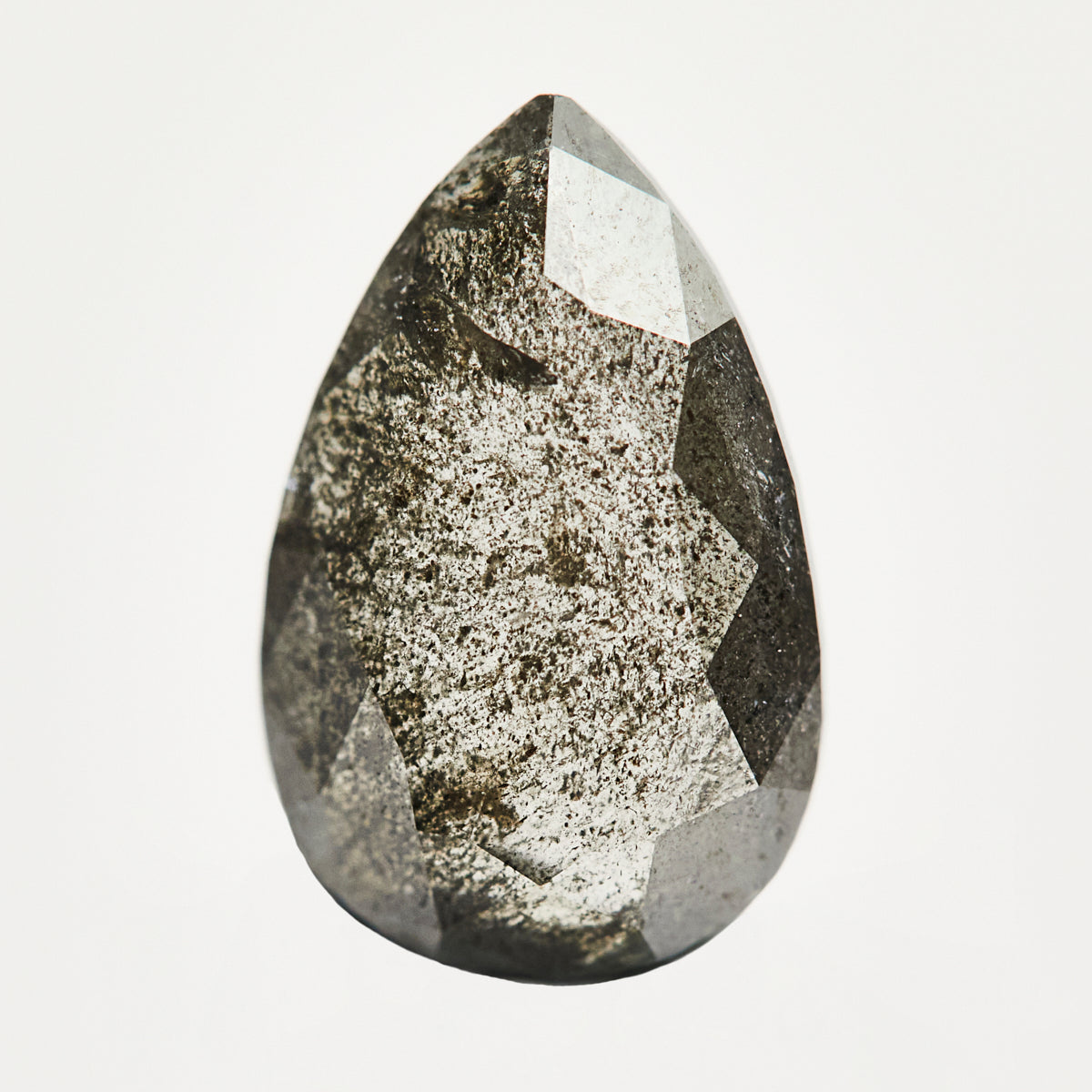 Alternative elongated pear-shaped rose-cut black raw salt and pepper diamond.