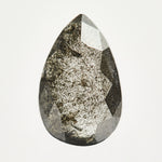 Alternative elongated pear-shaped rose-cut black raw salt and pepper diamond.