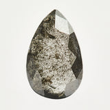 Alternative elongated pear-shaped rose-cut black raw salt and pepper diamond.