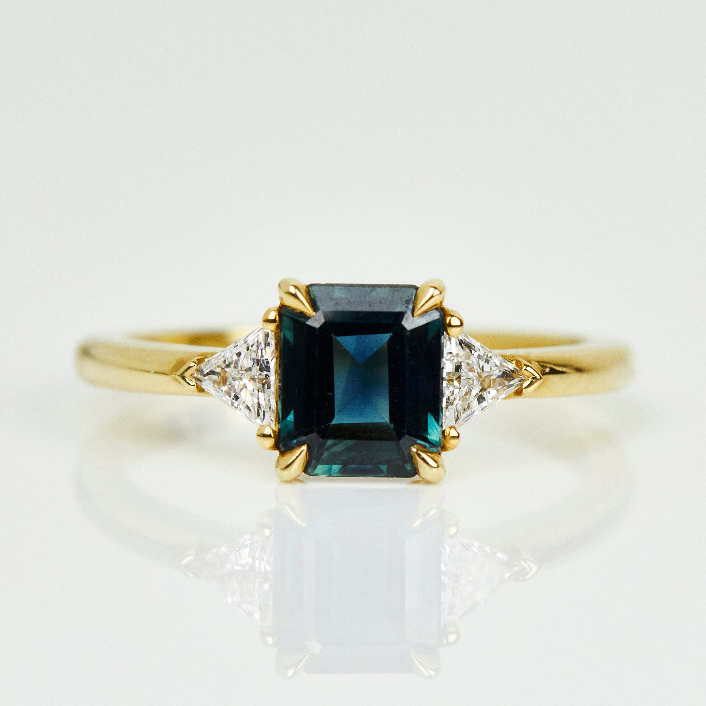 18ct yellow gold emerald cut trilogy ​teal sapphire rings