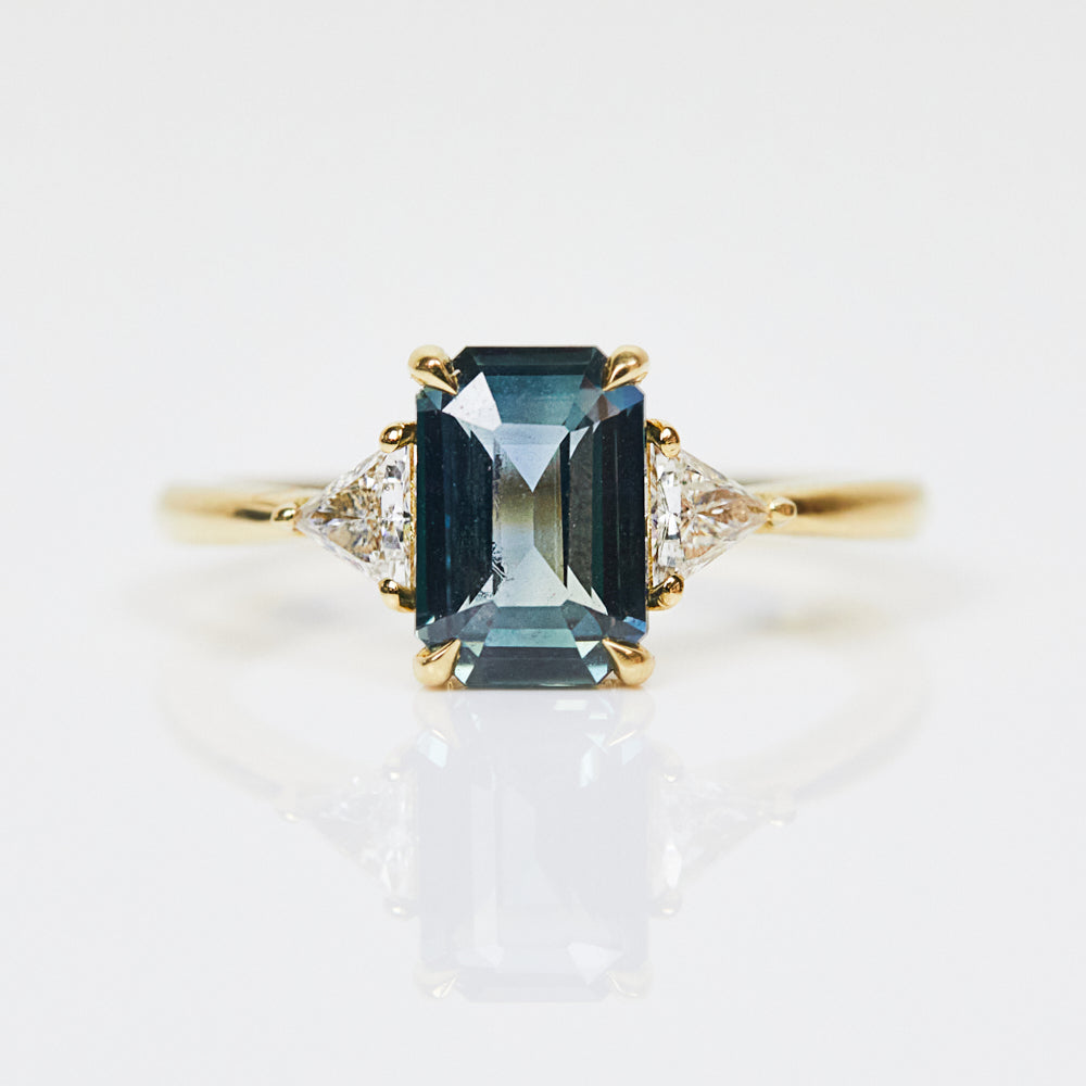 18ct yellow gold emerald cut trilogy ​teal sapphire rings
