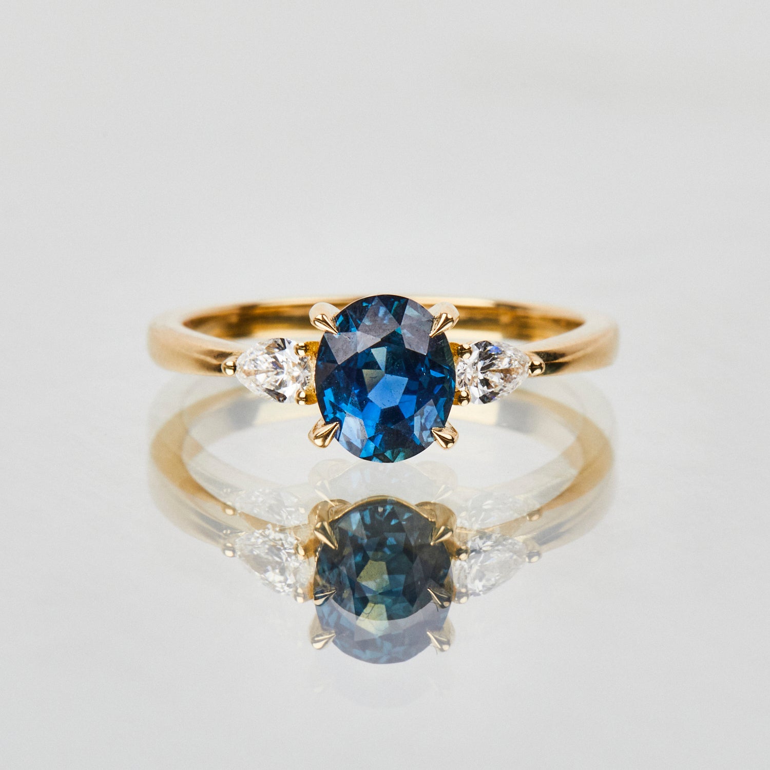 18ct yellow gold oval trilogy ​teal sapphire rings