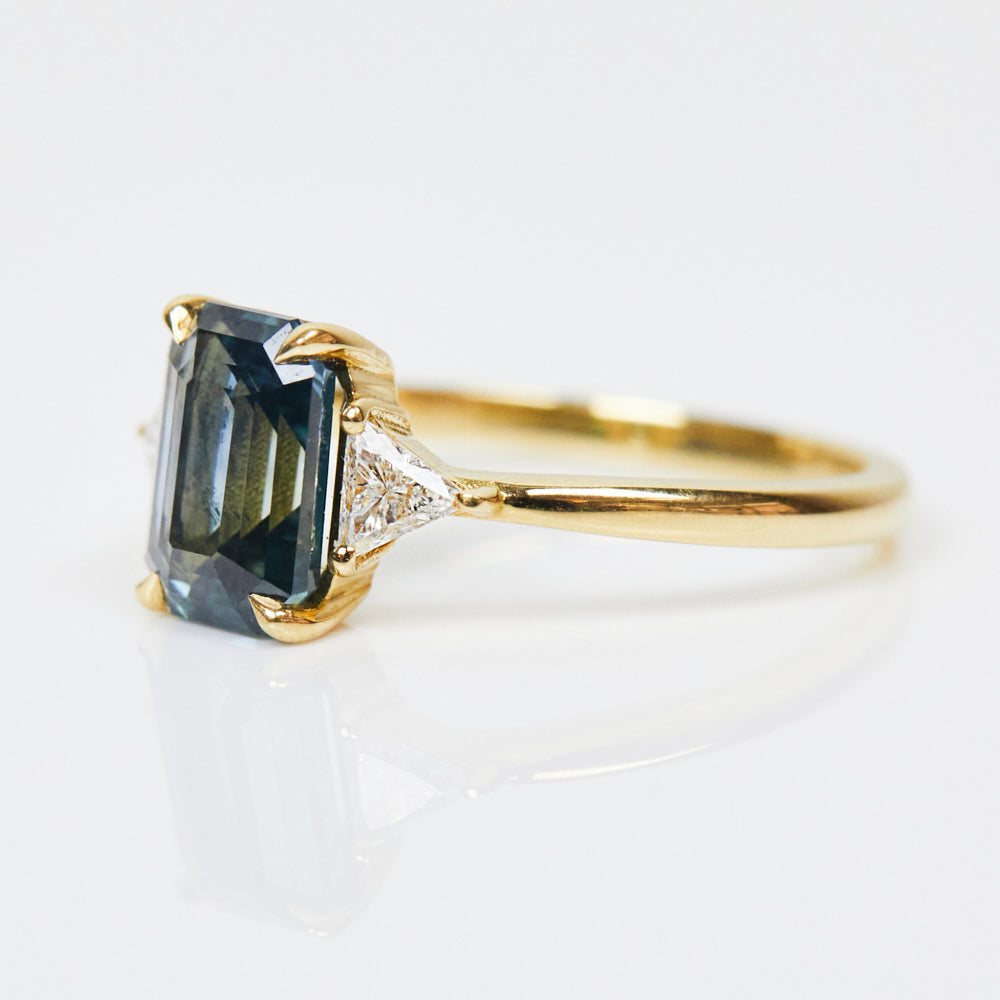 18ct yellow gold emerald cut trilogy ​teal sapphire rings