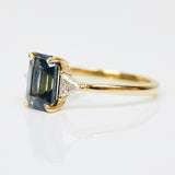 18ct yellow gold emerald cut trilogy ​teal sapphire rings