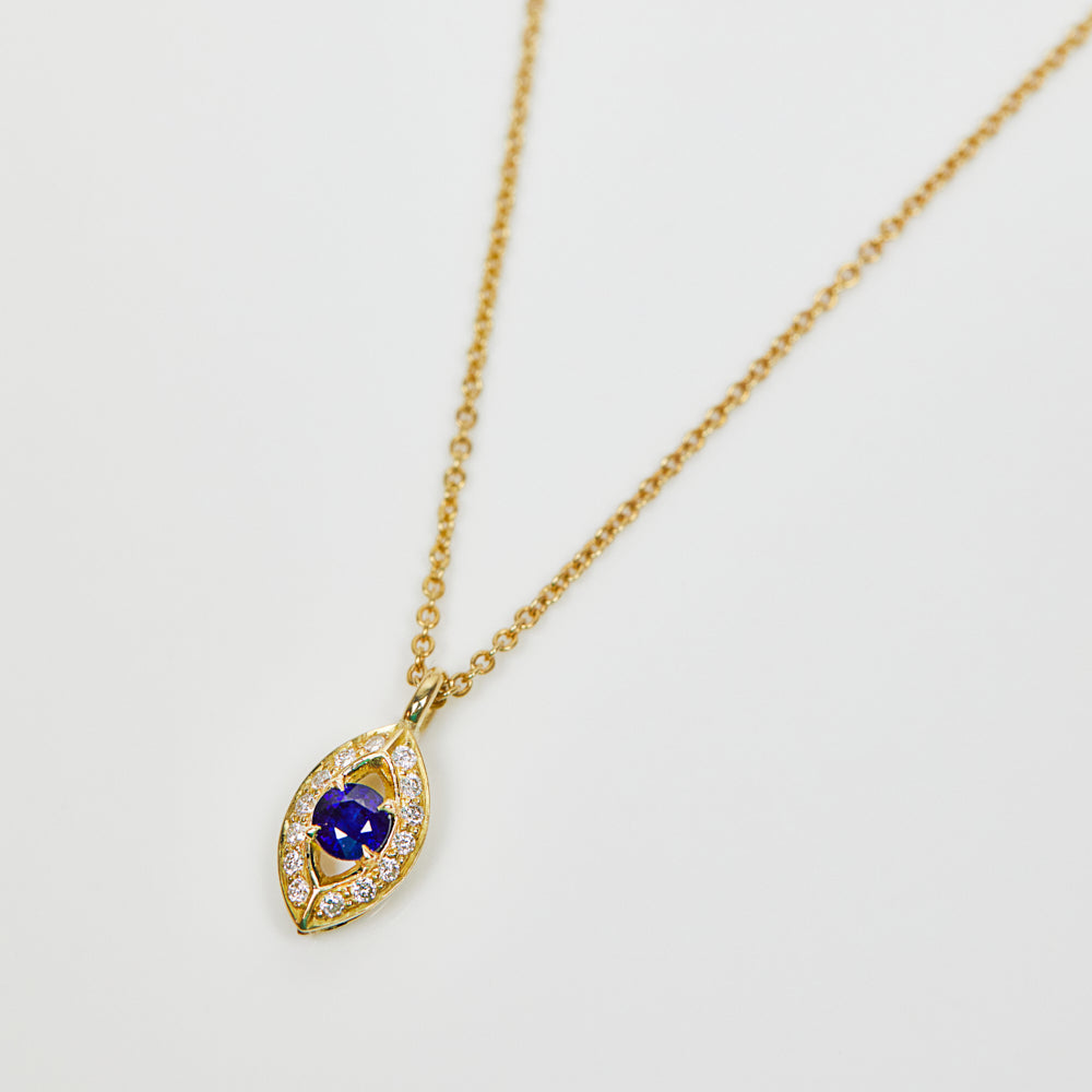 Blue sapphire evil eye necklace with diamonds in 18ct yellow gold.
