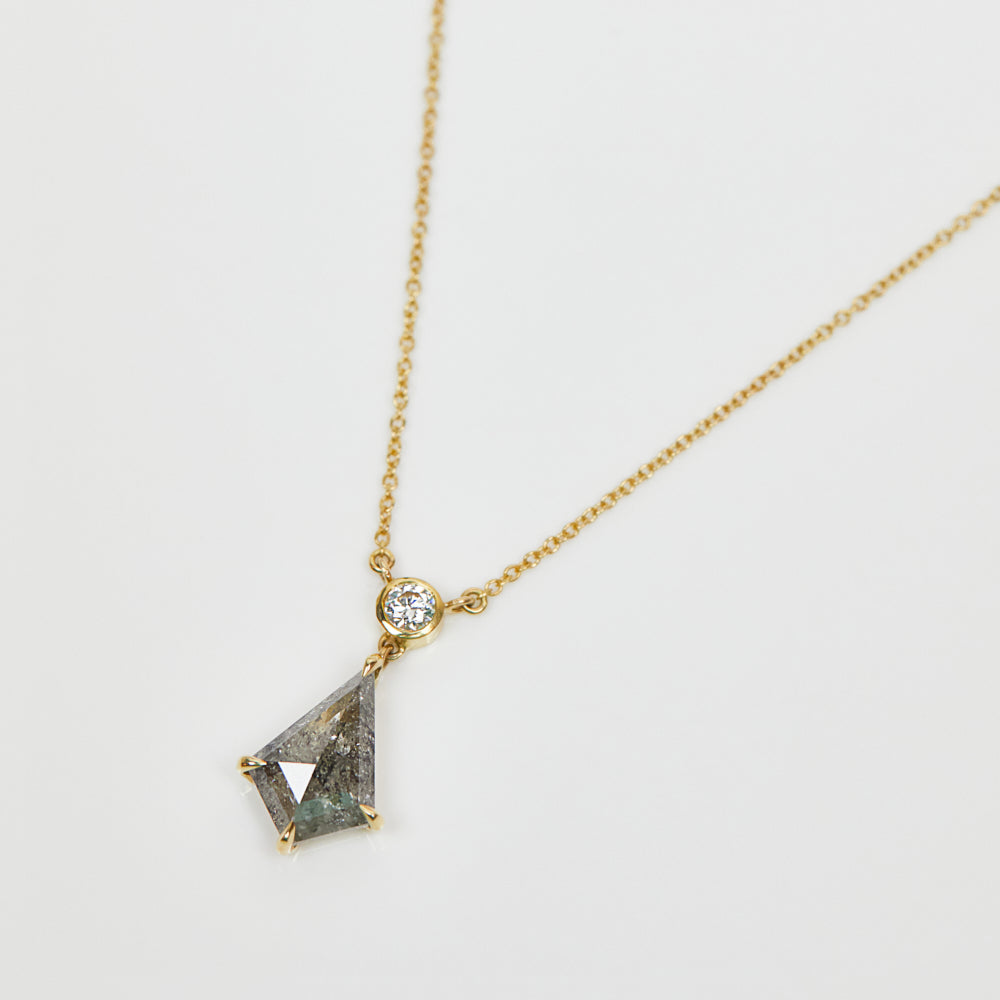 Kite-shaped salt and pepper diamond necklace in 18ct yellow gold.