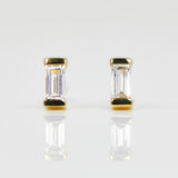 White baguette-cut lab-grown diamond earrings set in 18ct yellow gold.