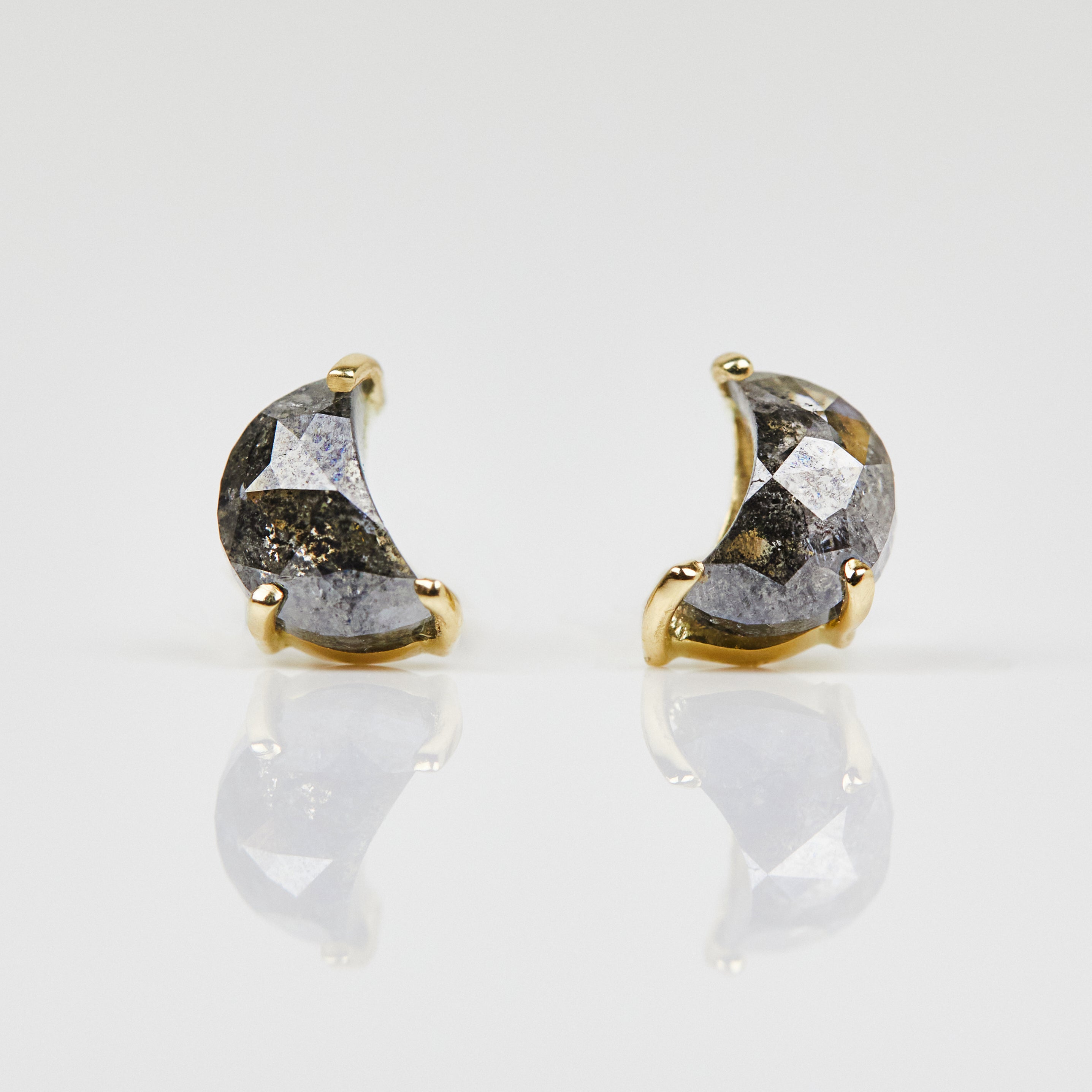 Salt and pepper crescent moon diamond earrings in yellow gold.