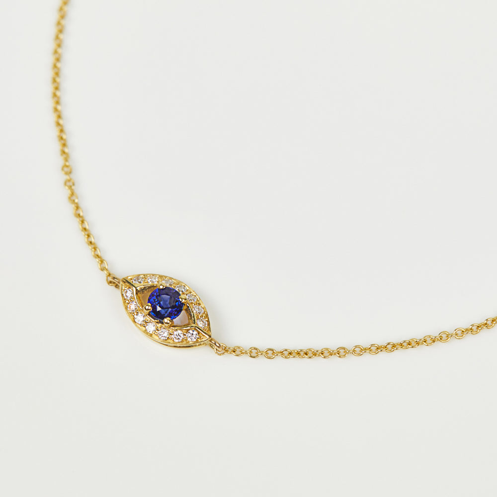 Blue sapphire evil eye bracelet with diamonds in 18ct yellow gold.