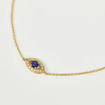 Blue sapphire evil eye bracelet with diamonds in 18ct yellow gold.