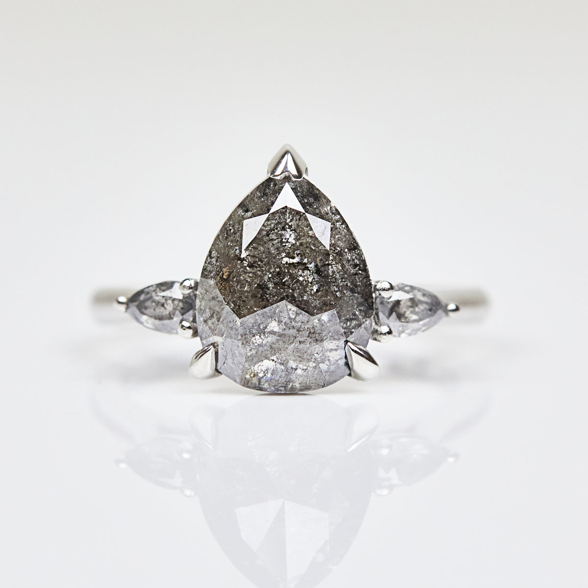 Platinum salt and pepper pear diamond engagement trilogy ring