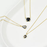 Black cushion cut diamond necklace in 18ct yellow gold.