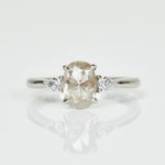 Platinum salt and pepper oval diamond engagement trilogy ring