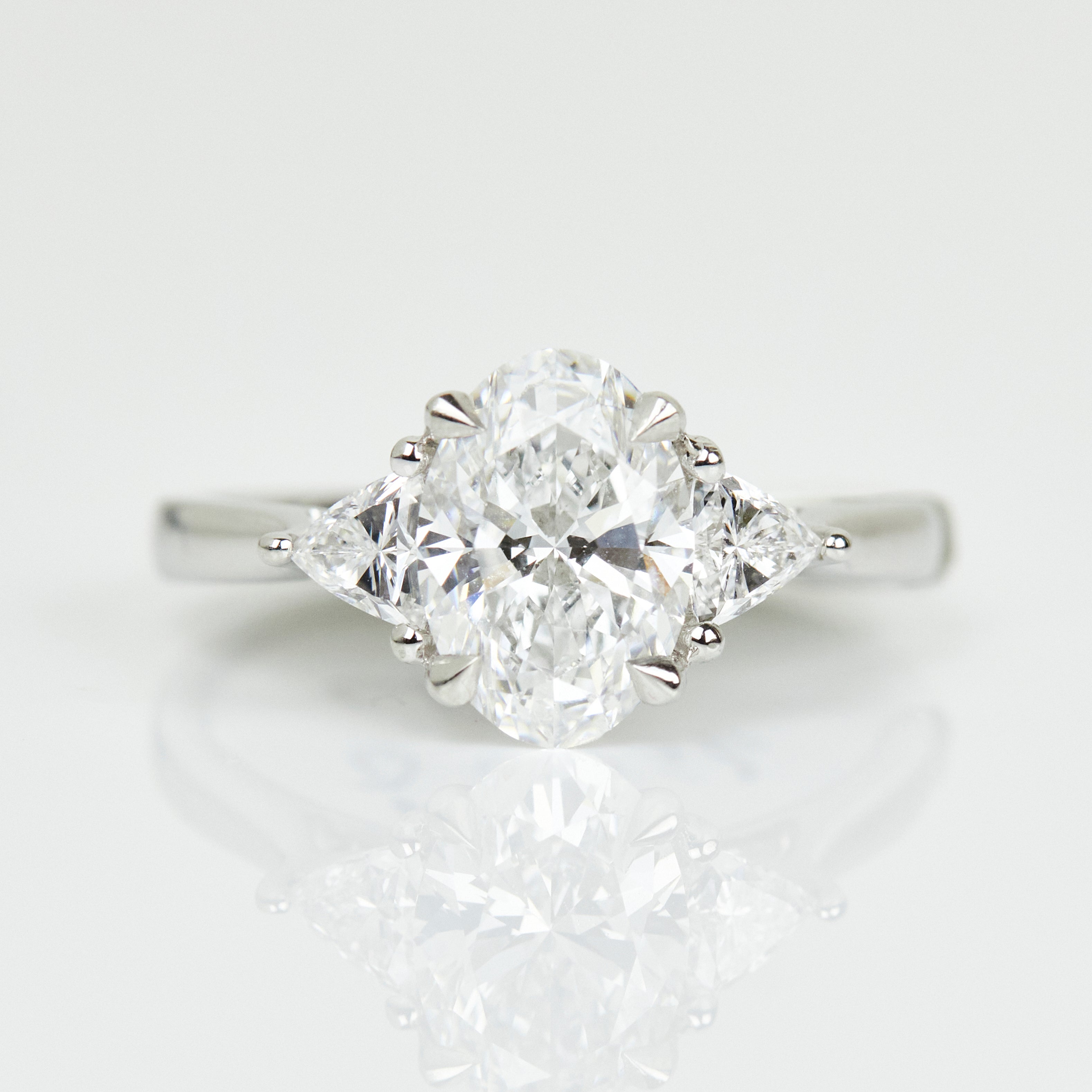 Platinum lab-grown oval diamond trilogy engagement ring