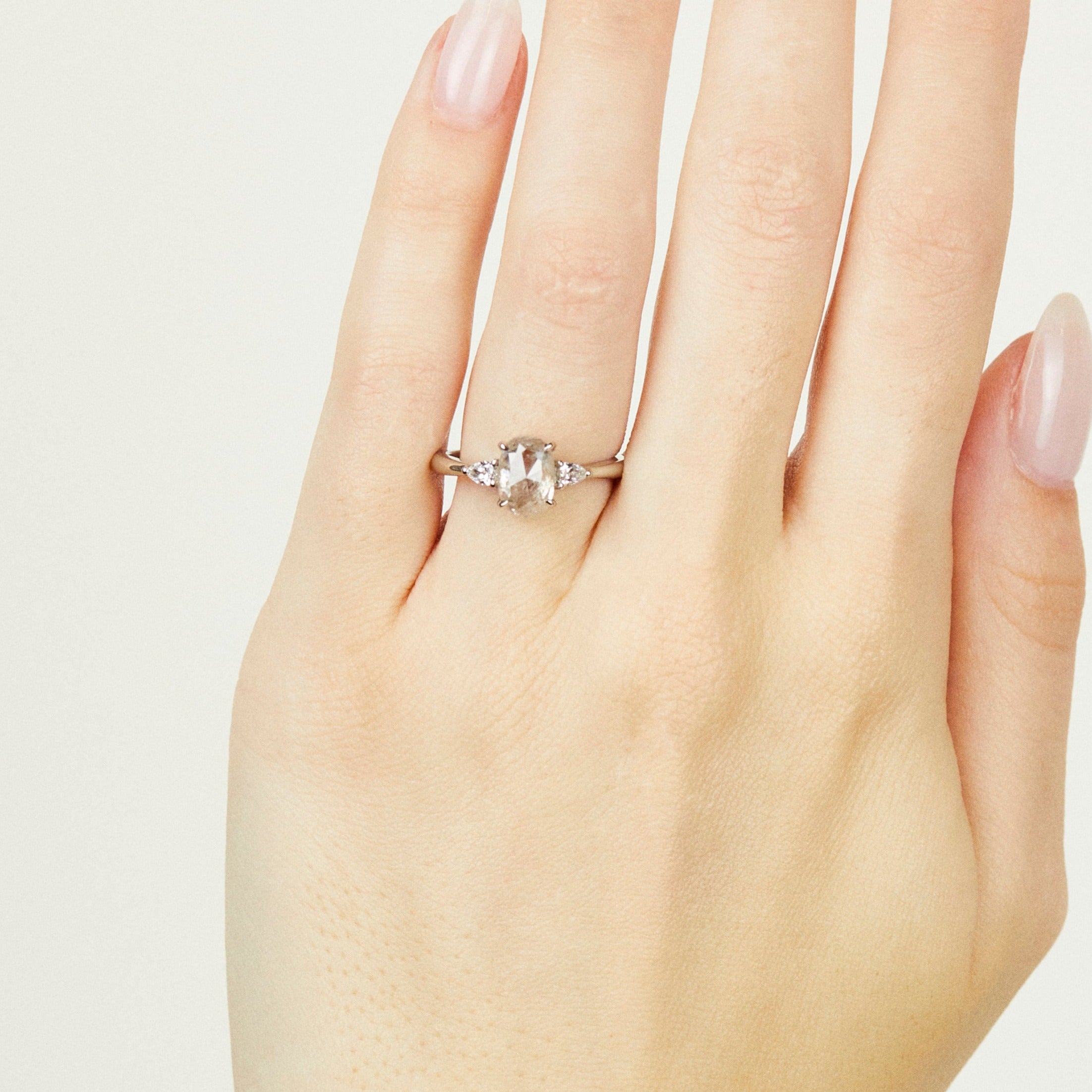 Platinum salt and pepper oval diamond engagement trilogy ring