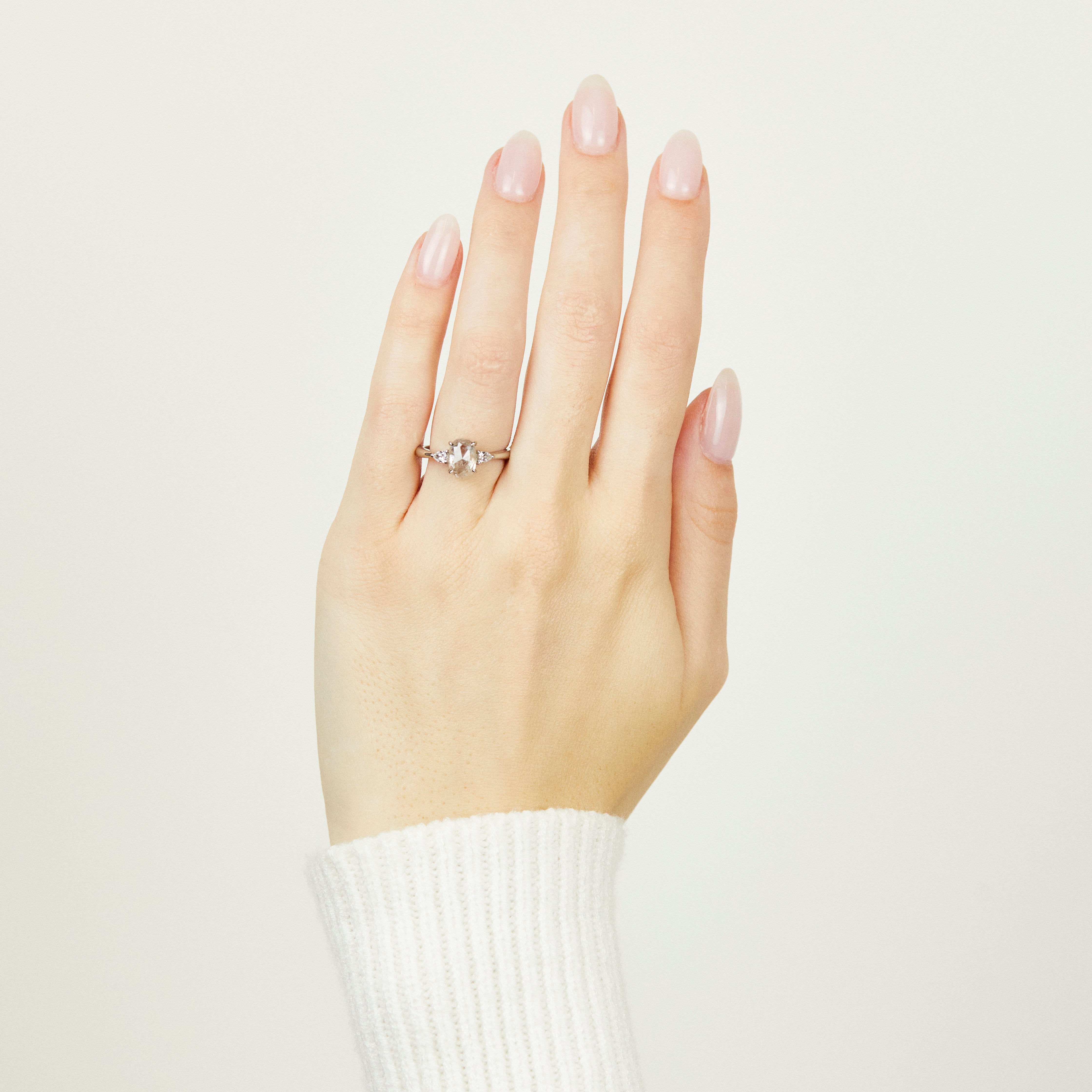 Platinum salt and pepper oval diamond engagement trilogy ring