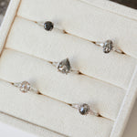Platinum salt and pepper oval diamond engagement trilogy ring