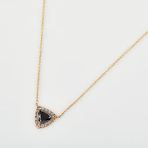 Black diamond triangle halo necklace with white diamonds in 18ct yellow gold.