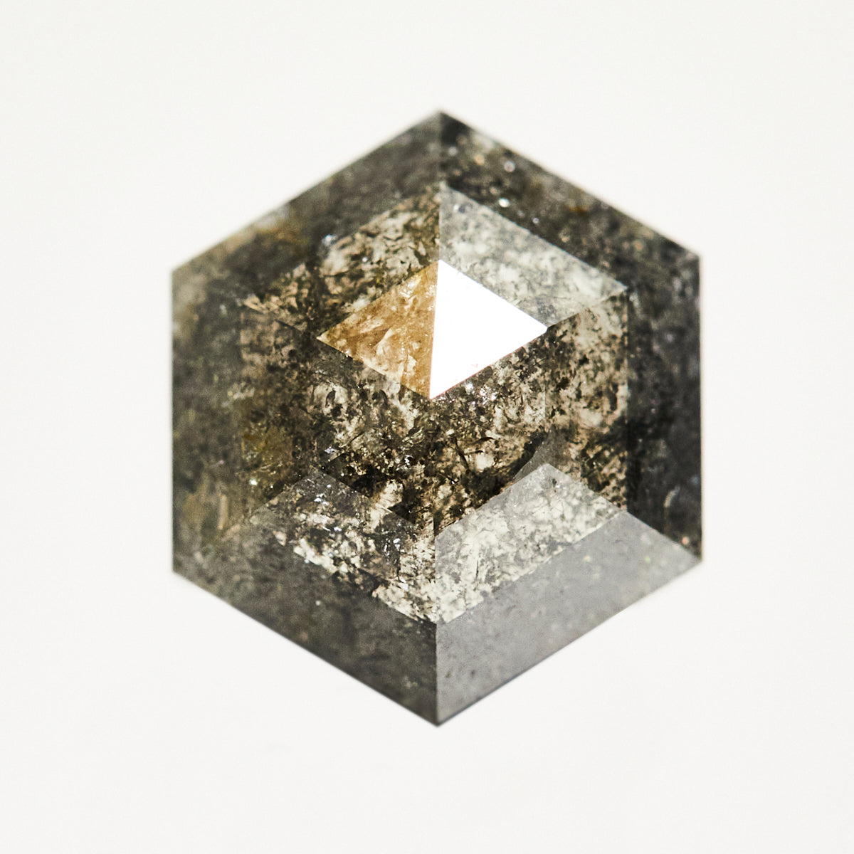 Dark hexagon rose-cut raw salt and pepper diamond.