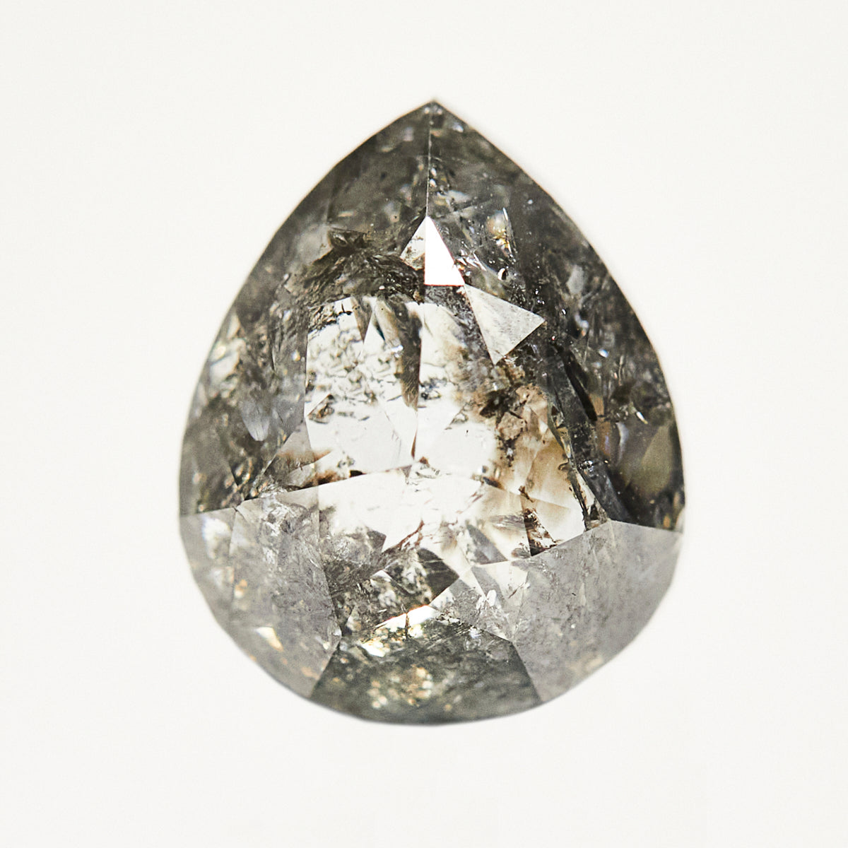 Dark pear-shaped rose-cut black salt and pepper diamond.