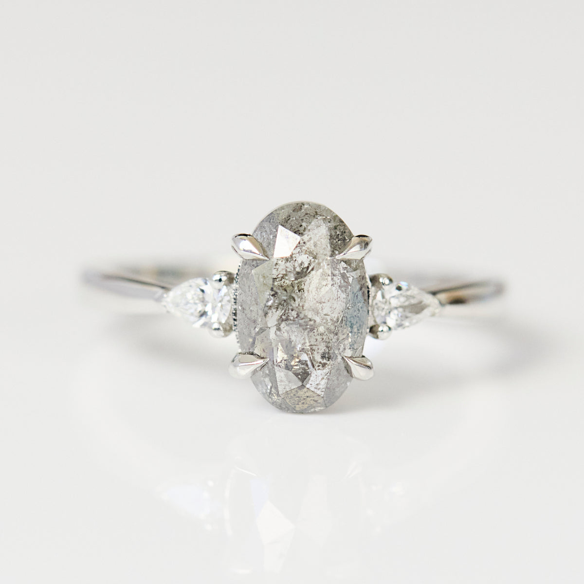 Platinum oval salt and pepper diamond trilogy