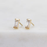 White baguette-cut lab-grown diamond earrings set in 18ct yellow gold.
