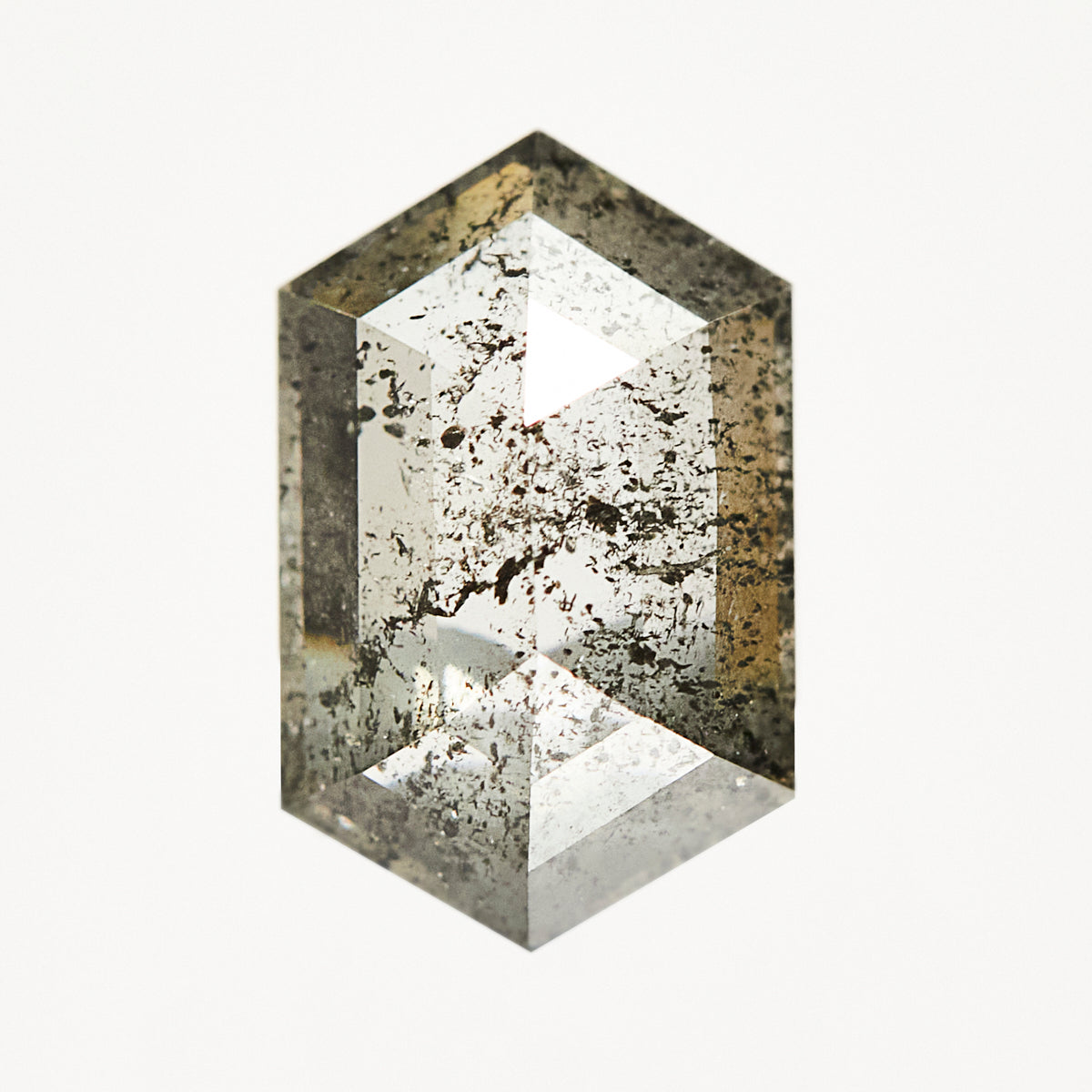 Elongated hexagon rose-cut loose salt and pepper diamond with black inclusions.
