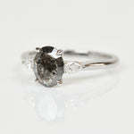 Platinum salt and pepper oval diamond engagement trilogy ring