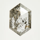Elongated hexagon rose-cut speckled salt and pepper diamond.