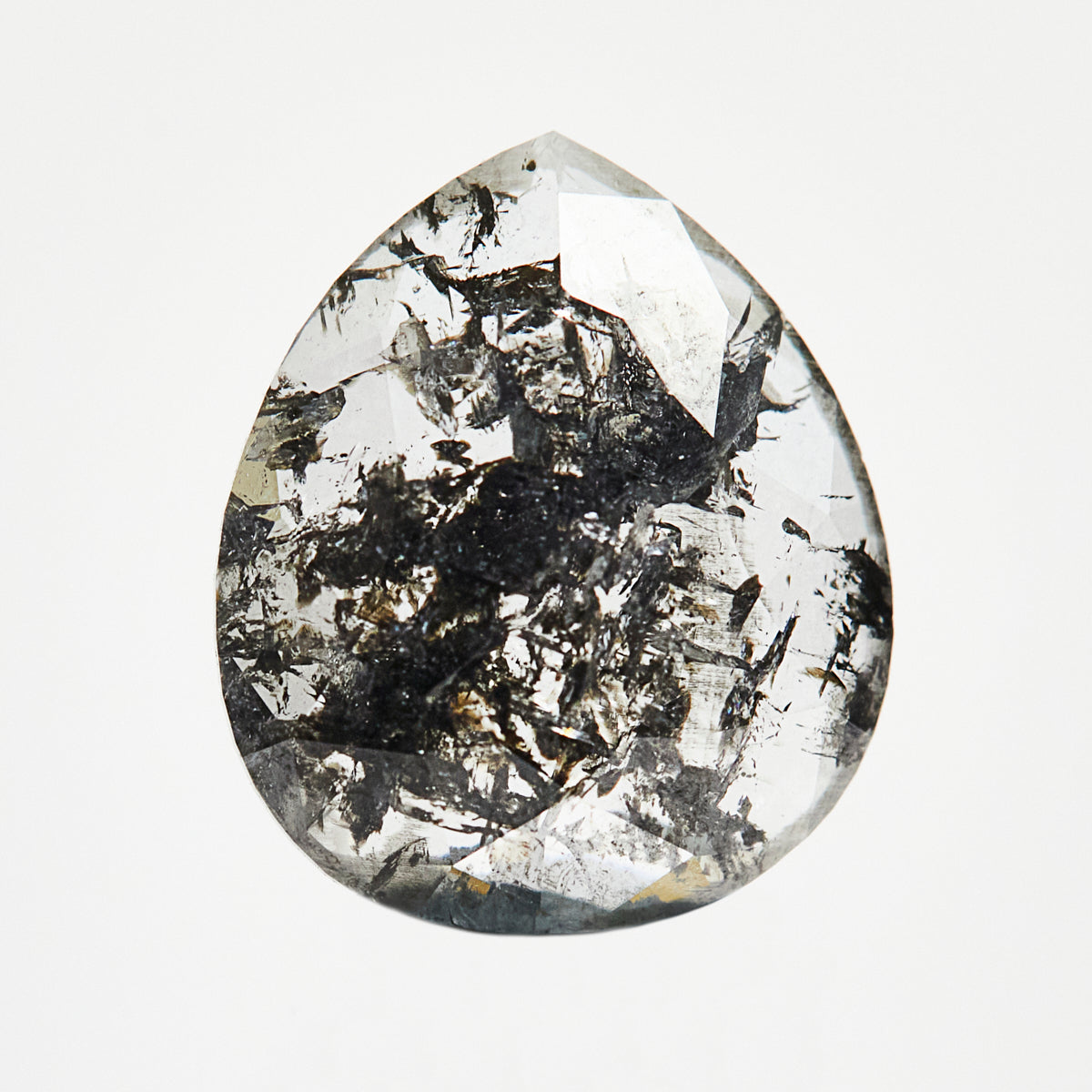 Modern pear-shaped rose-cut salt and pepper diamond with speckled inclusions.