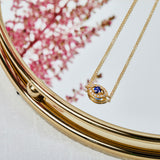 Blue sapphire evil eye necklace with diamonds in 18ct yellow gold.