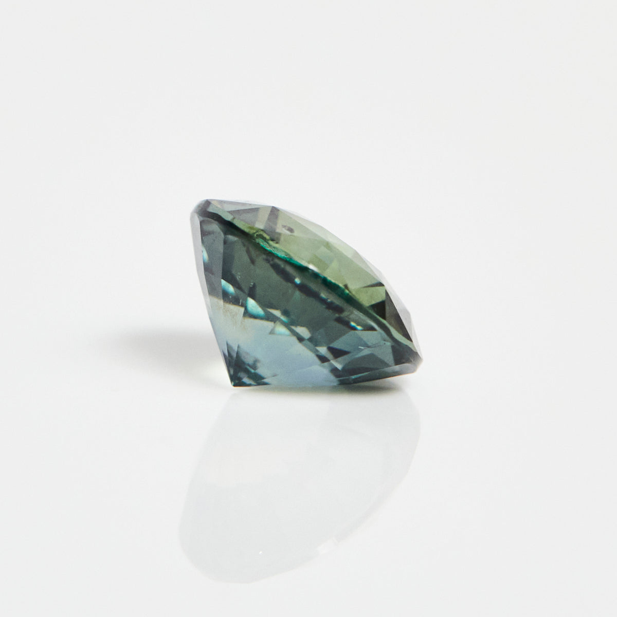 Ethical unheated round brilliant-cut teal sapphire gemstone.