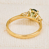 An 18ct yellow gold engagement ring with a decorative cathedral setting with an oval sapphire centre stone