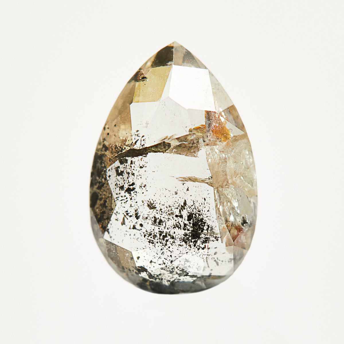 Alternative pear-shaped rose-cut raw salt and pepper diamond.