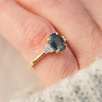 australian oval teal sapphire engagement ring with round diamond side stones