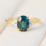australian oval teal sapphire engagement ring with round diamond side stones