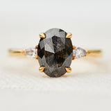 black oval salt and pepper diamond engagement ring in yellow gold