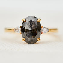 black oval salt and pepper diamond engagement ring in yellow gold