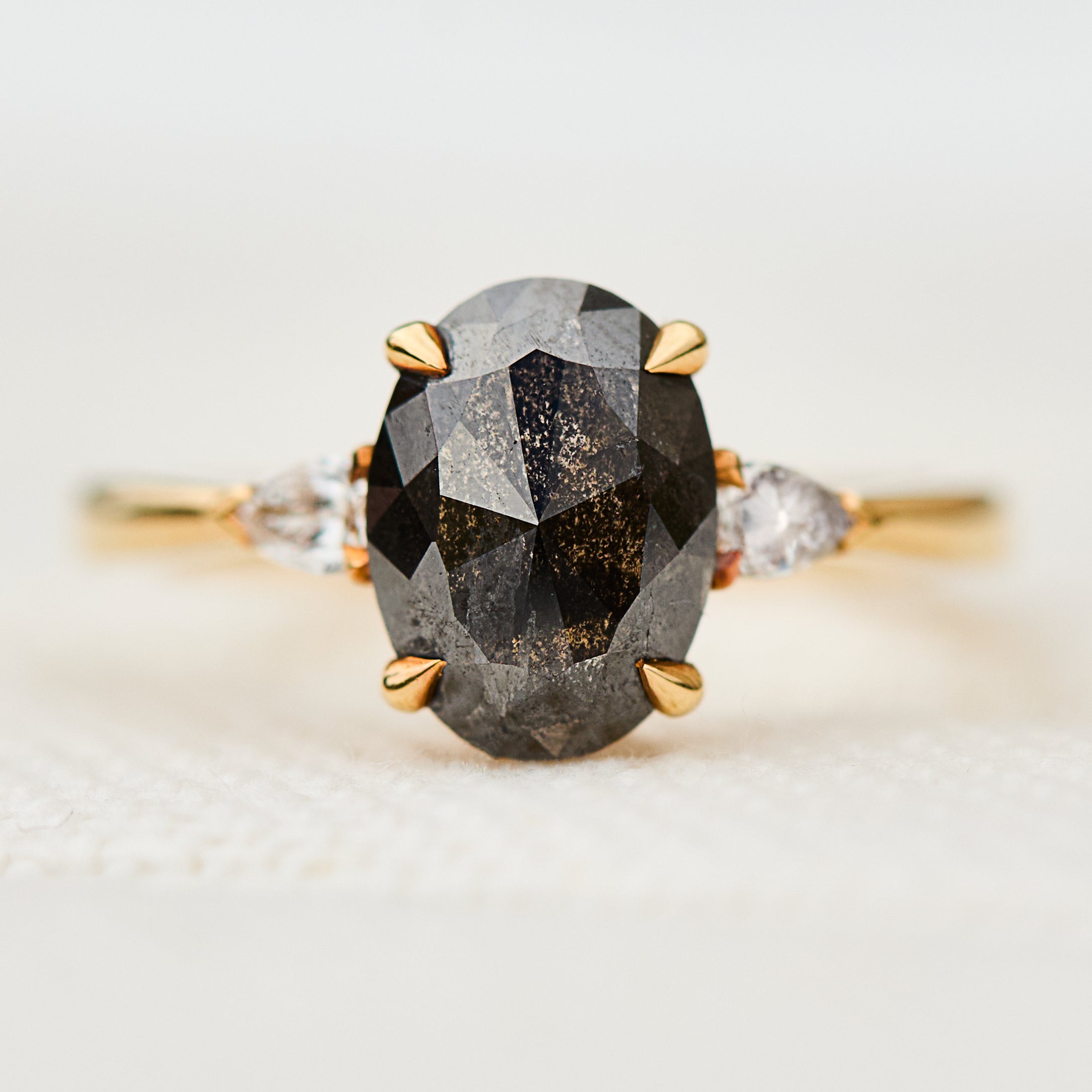 black oval salt and pepper diamond engagement ring in yellow gold